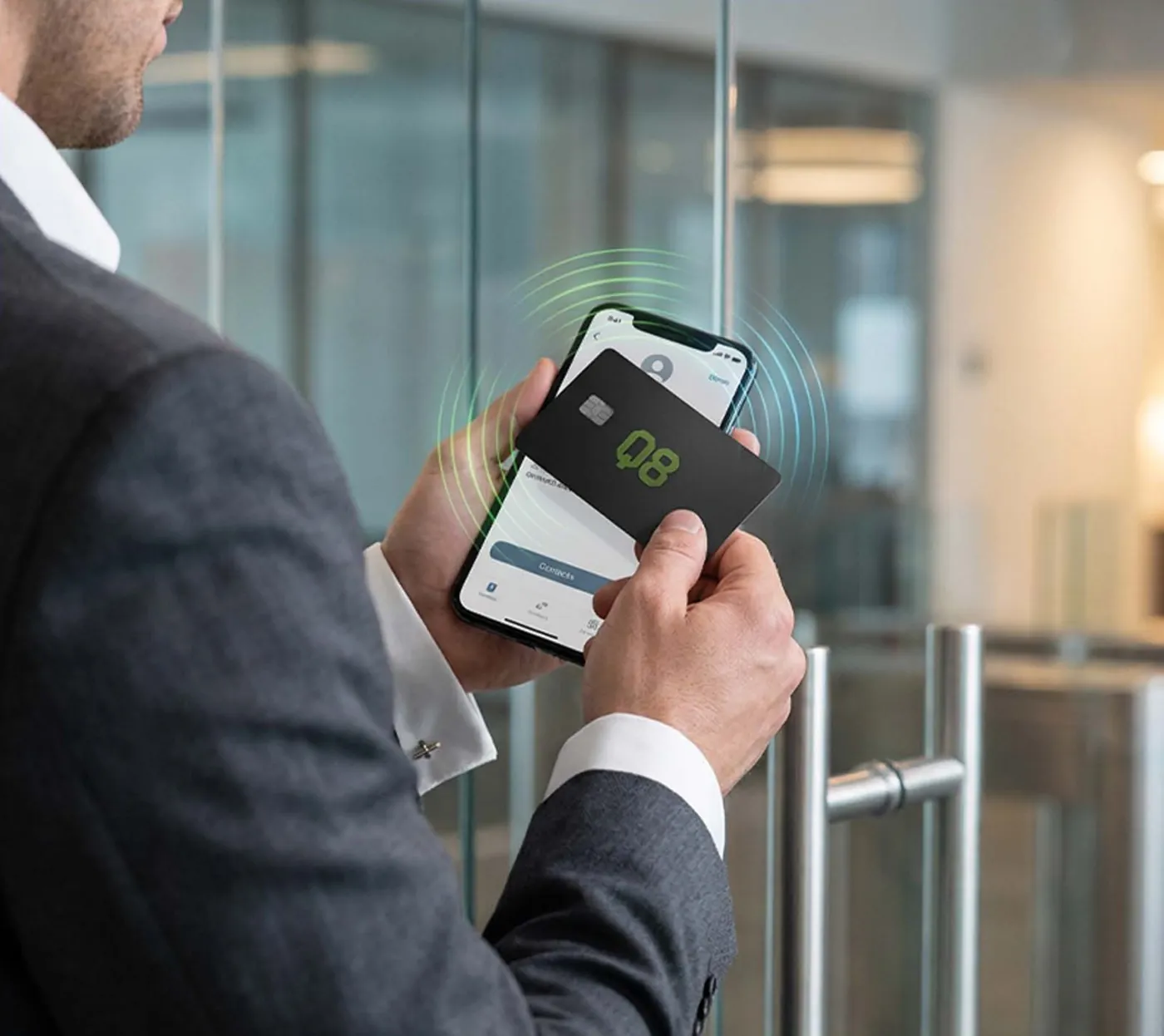 A black Q8 NFC business card tapped on a smartphone